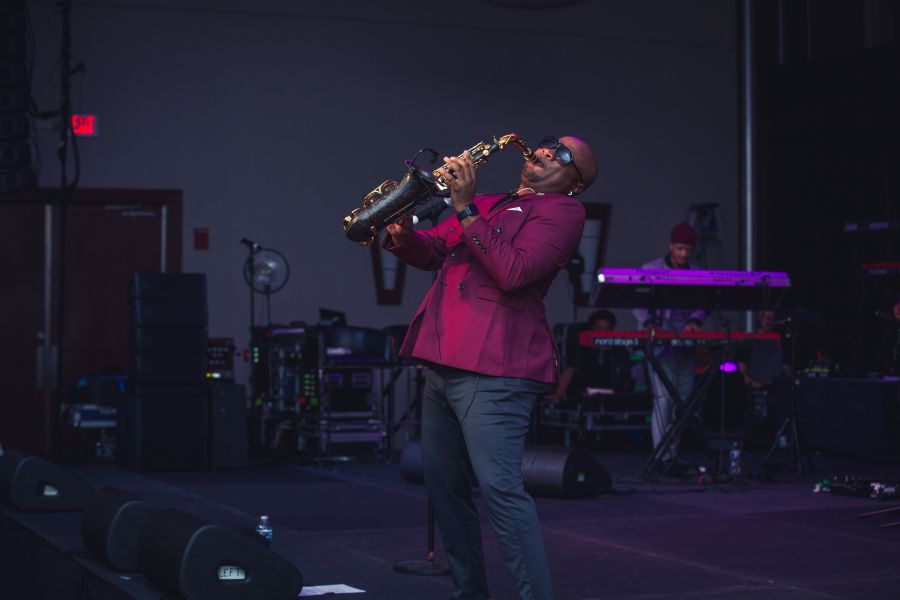 An NCCU Jazz Studies alumni plays saxophone on stage.