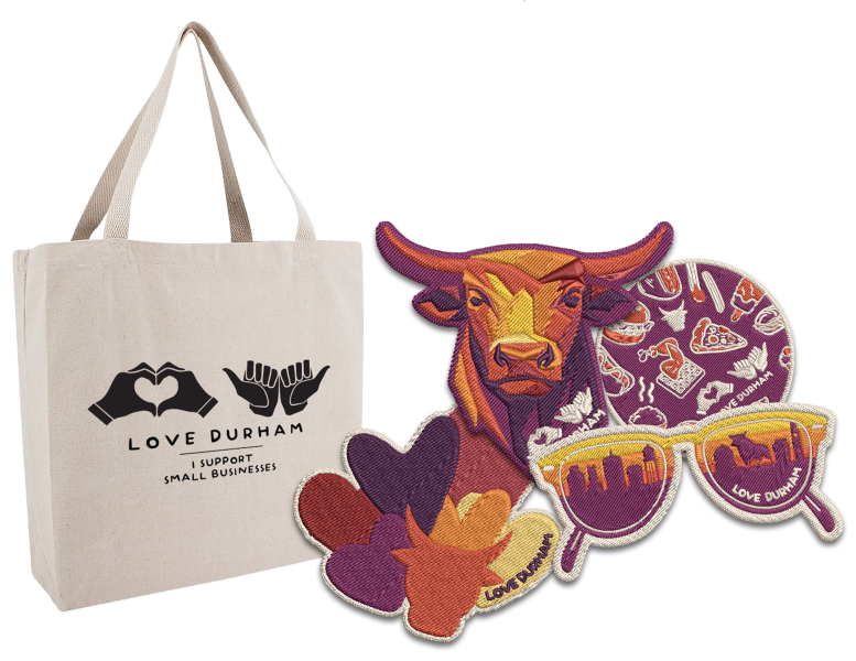 A Love Durham tote and four patches: a bull, sunglasses, hearts and food items.