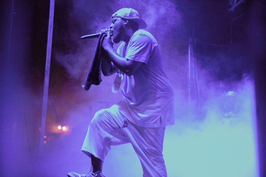 Blue light and smoke bathe a performer on stage at Beats N Bars in Durham.