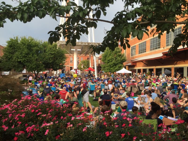 A crowd gathers on the lawn at ATC to enjoy live music.