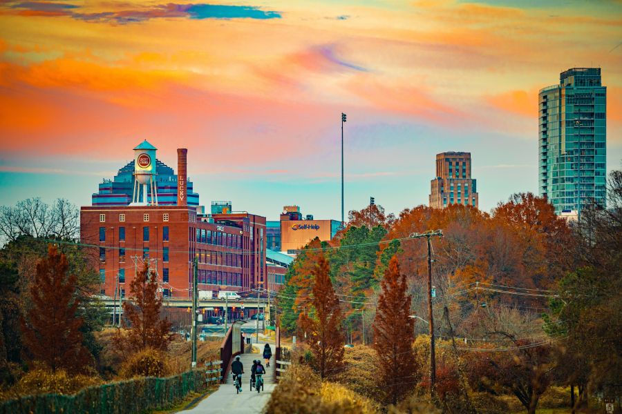 Bikers ride down the American Tobacco Trail in Durham at sunset.