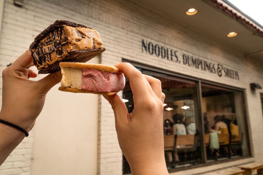 Hands hold up artisanal ice cream sandwiches from Rose's in Durham, NC.