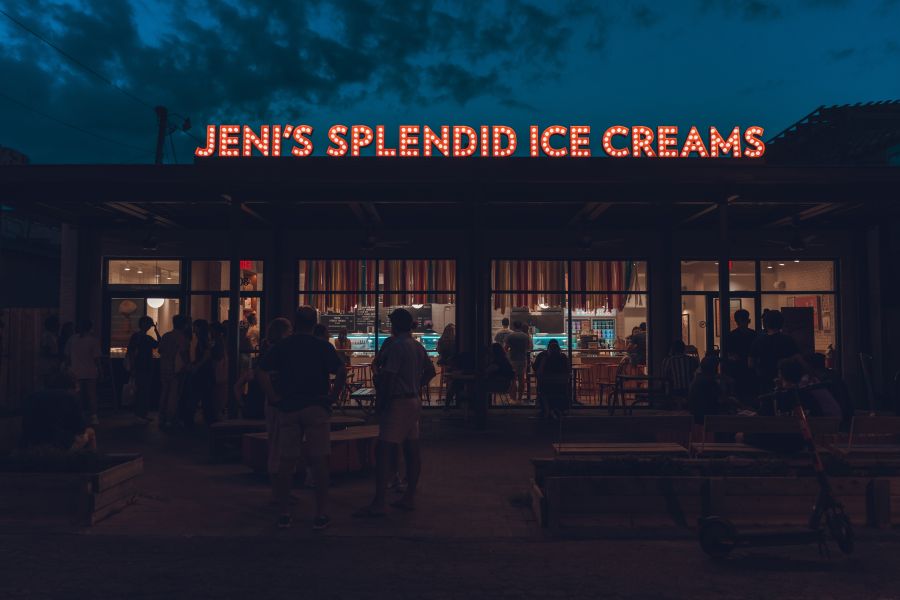 The neon Jeni's Splendid Ice Cream's sign shines in the dark just after dusk.