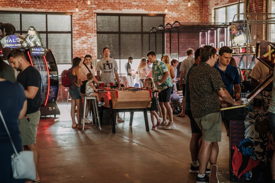 Gamers play air hockey and other games at Durham's Boxcar Bar + Arcade.