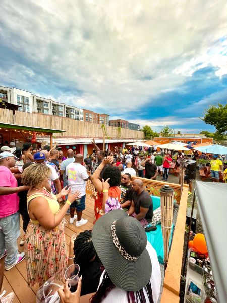 Customers sit and socialize with drinks on the back patio at Pickleback 2.