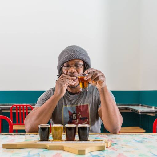 A customer savors a flight of seasonal beers at Fullsteam Brewery in Durham, NC