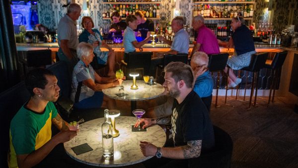 Guests enjoy drinks at Corpse Reviver in Durham, NC.