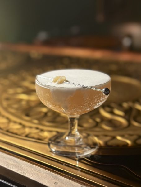 A mocktail from Arcana sits unassumingly on a table, waiting to be enjoyed.