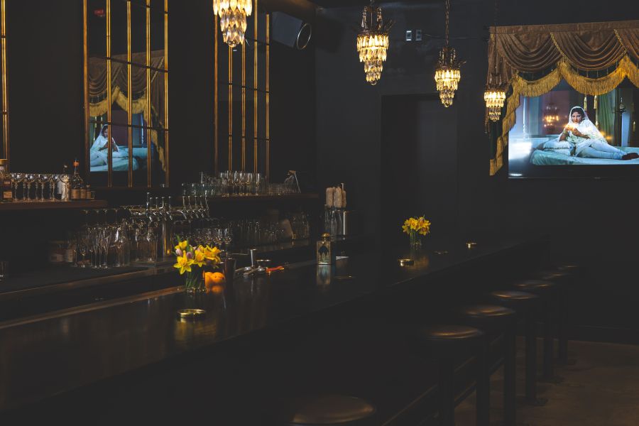 Dim lights illuminate the intimate bar at Bar Beej.