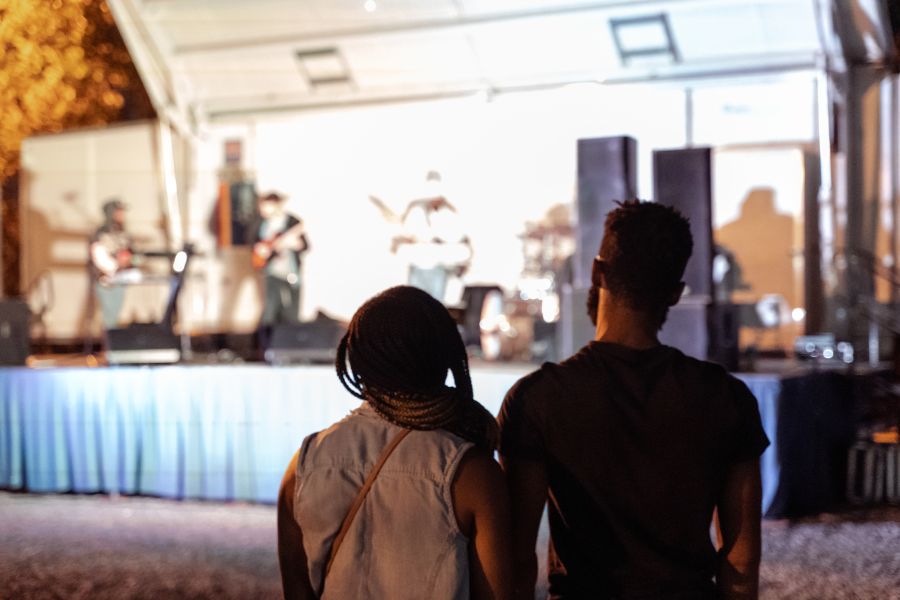 Two festival-goers enjoy a musical performance at Blacktoberfest in Durham.