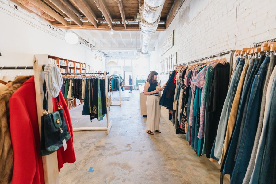 A woman browses the racks in a Durham, NC vintage clothing store