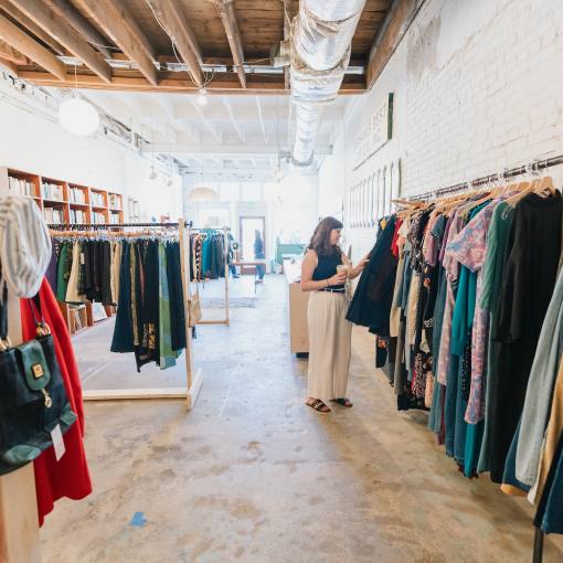 A woman browses the racks in a Durham, NC vintage clothing store