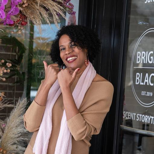 The owner of Bright Black shows the &quot;Love Durham&quot; bull horns in front of the store.
