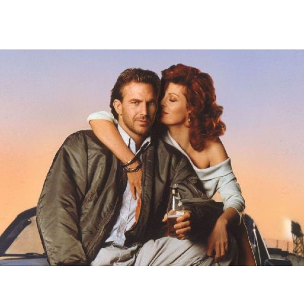The movie poster for Bull Durham features Kevin Costner and co-star Susan Sarandon sitting on a car.