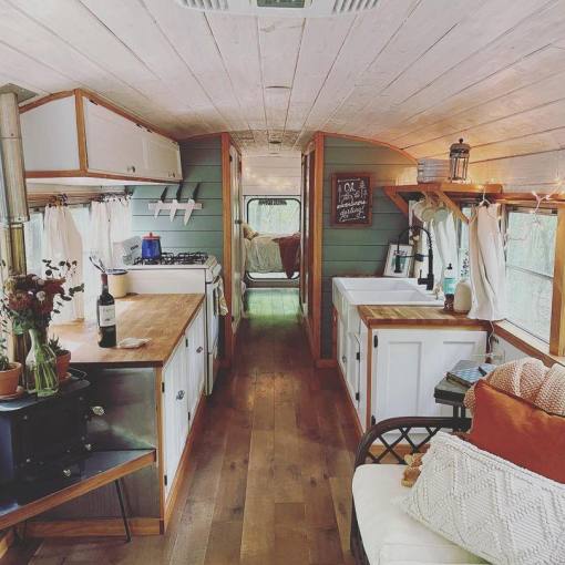 A bus converted into an Airbnb exudes a calm, rustic vibe, inviting guests to come in and relax.