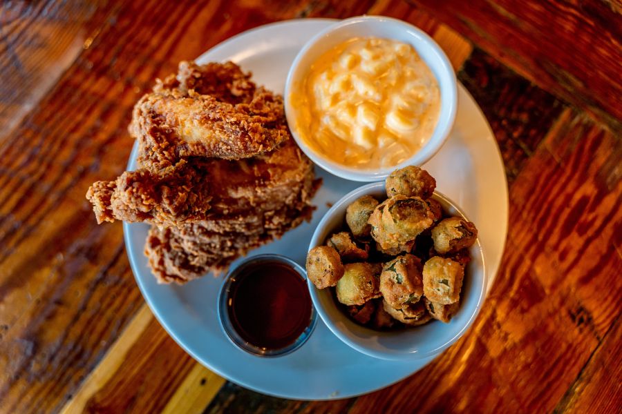 Bowls of fried okra and mac n' cheese compliment a generous helping of fried chicken from Picnic Barbecue in Durham, NC.