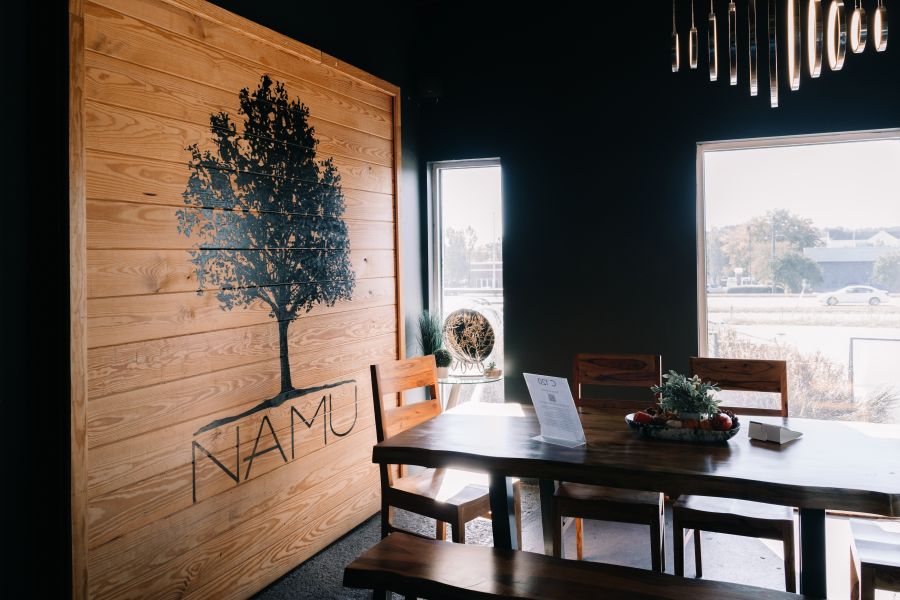 Namu's cozy seats, low light, and earth tones offer a tranquil retreat for cafe visitors.