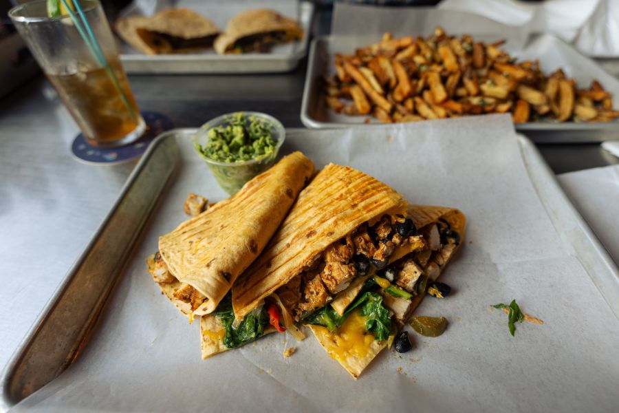 A quesadilla and fries sit on wax paper trays at The Federal in Durham, NC.