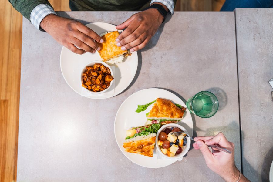 An aerial view shows two diners digging into lunch plates from Monuts in Durham.