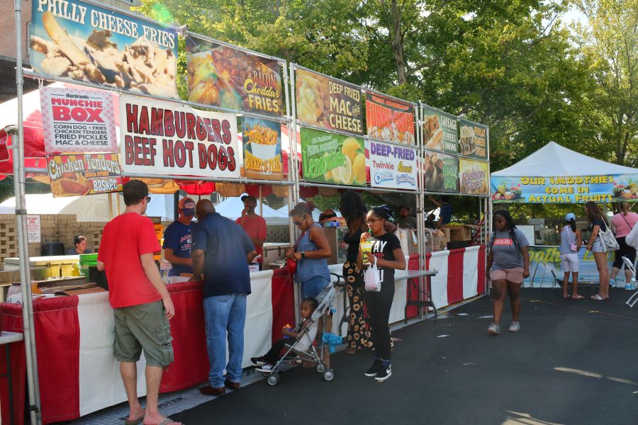 Festival goers line up to get fair food at a stand at CenterFest.