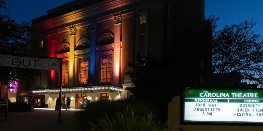 Lights shine a rainbow flag over the Carolina Theatre during the OutSouth Queer Film Festival.