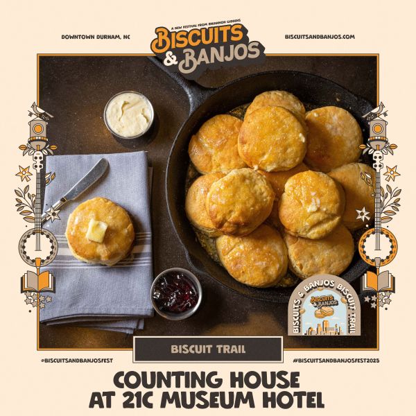 A cast iron pan filled with golden brown biscuits, and sides of butter and jam