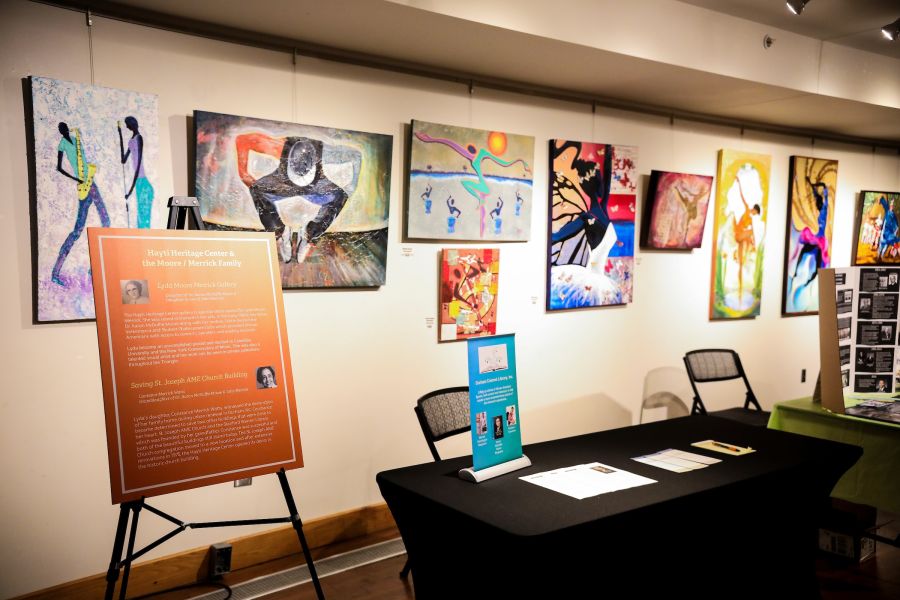 Art from the Founding Fathers of Hayti exhibit lines the walls of the Hayti Heritage Center.