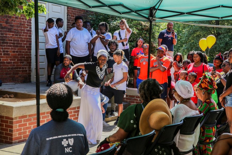 Aya Shabu performs for a crowd in front of Hayti Heritage Center.