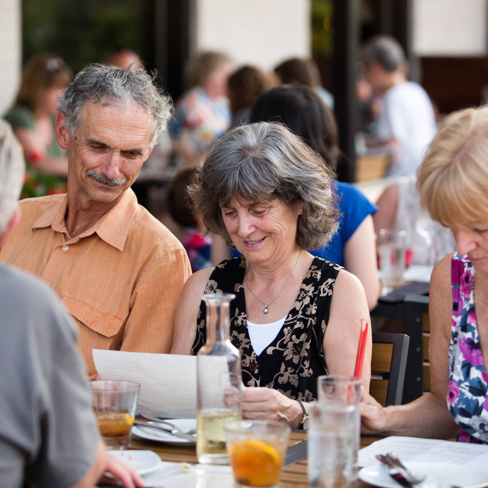 A group of elderly men and women enjoy a meal at Juju Durham.