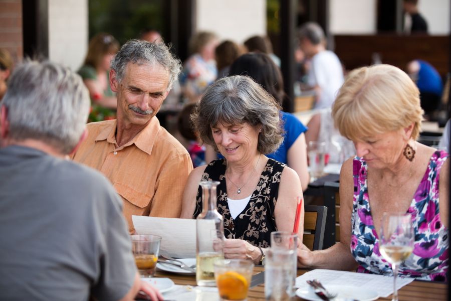 A group of elderly men and women enjoy a meal at Juju Durham.