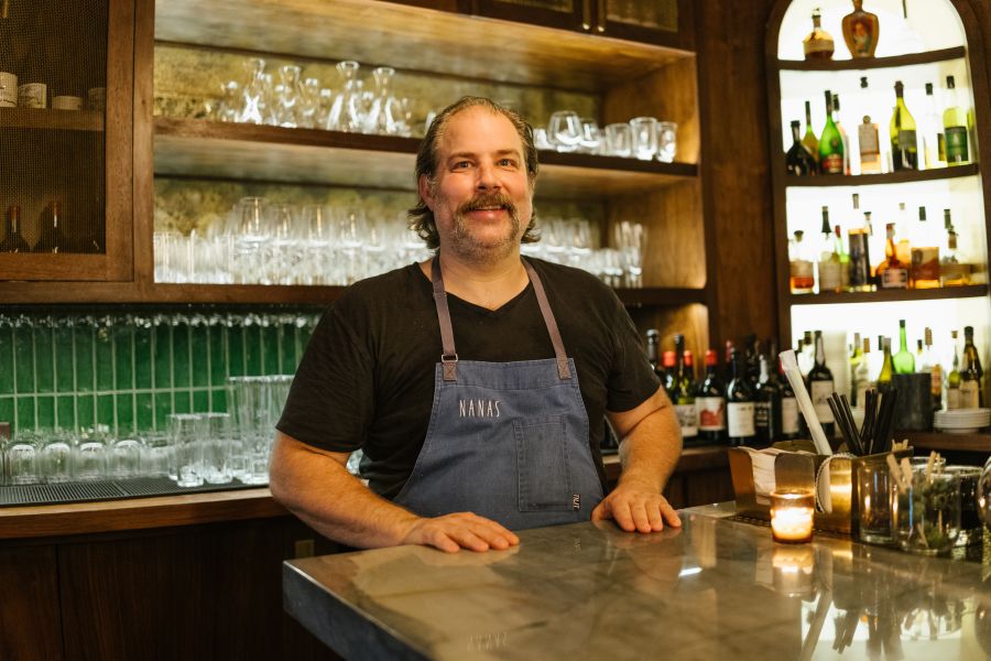 Chef Matt Kelly poses for a photo behind the bar at Nana's in Durham, NC.