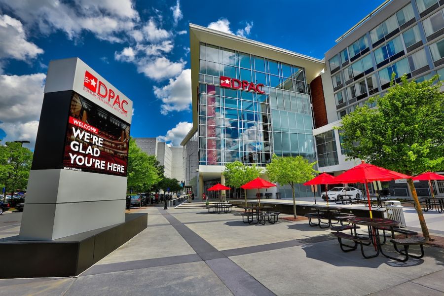 The venue front of Durham Performing Arts Center welcomes viewers on a sunny day.