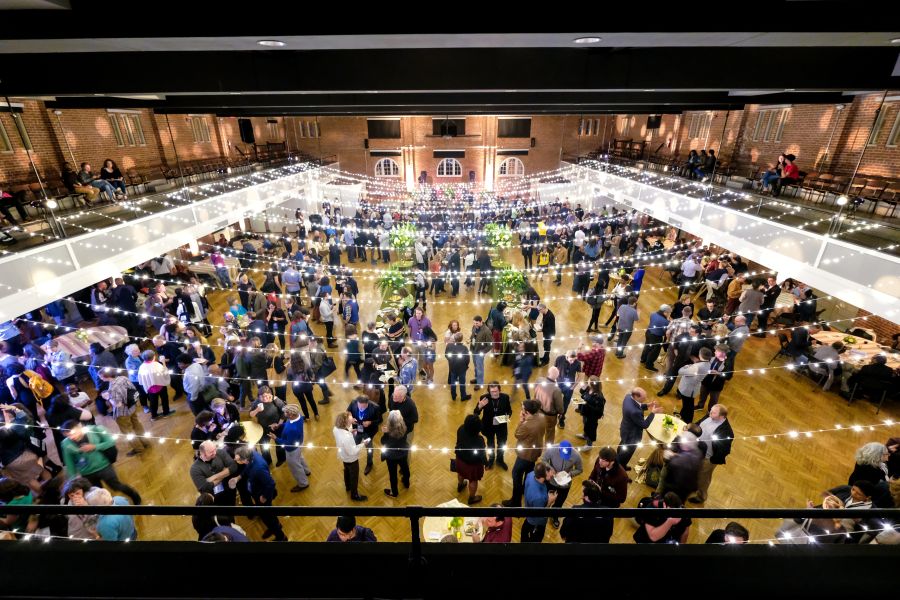 Festival goers gather under string lights at The Durham Armory during the Full Frame Film Festival.