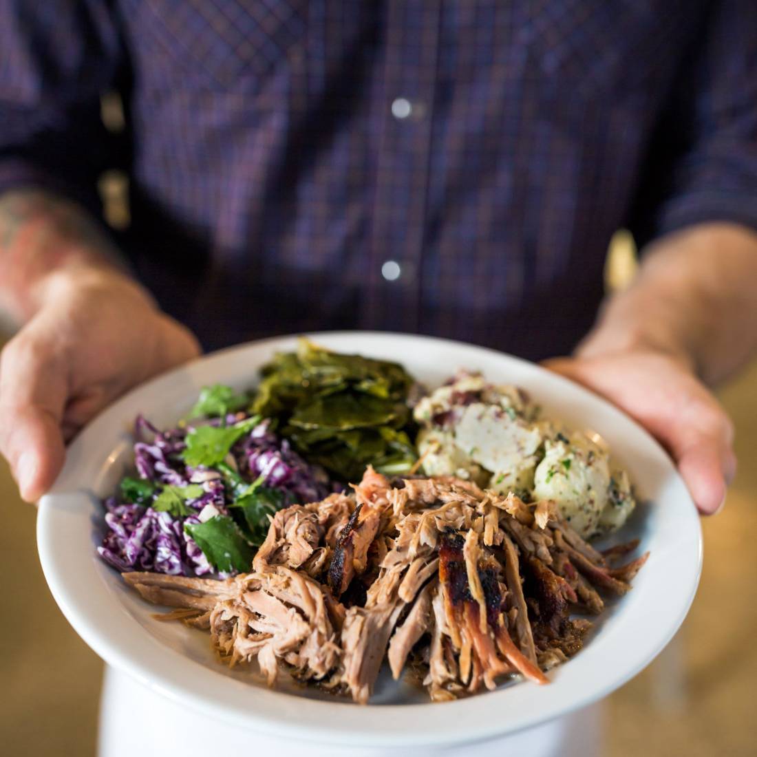waiter holding plate of food
