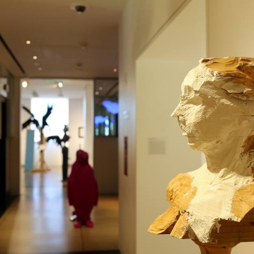 A statue foregrounds a still from the 21c Museum Hotel in Durham.