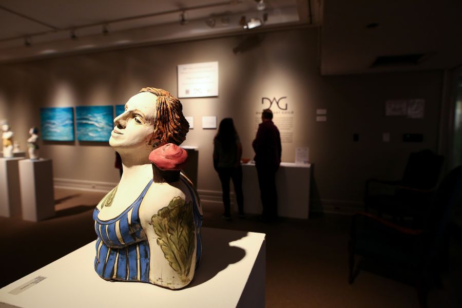 sculptures sit under spotlights in the Durham Arts Council.