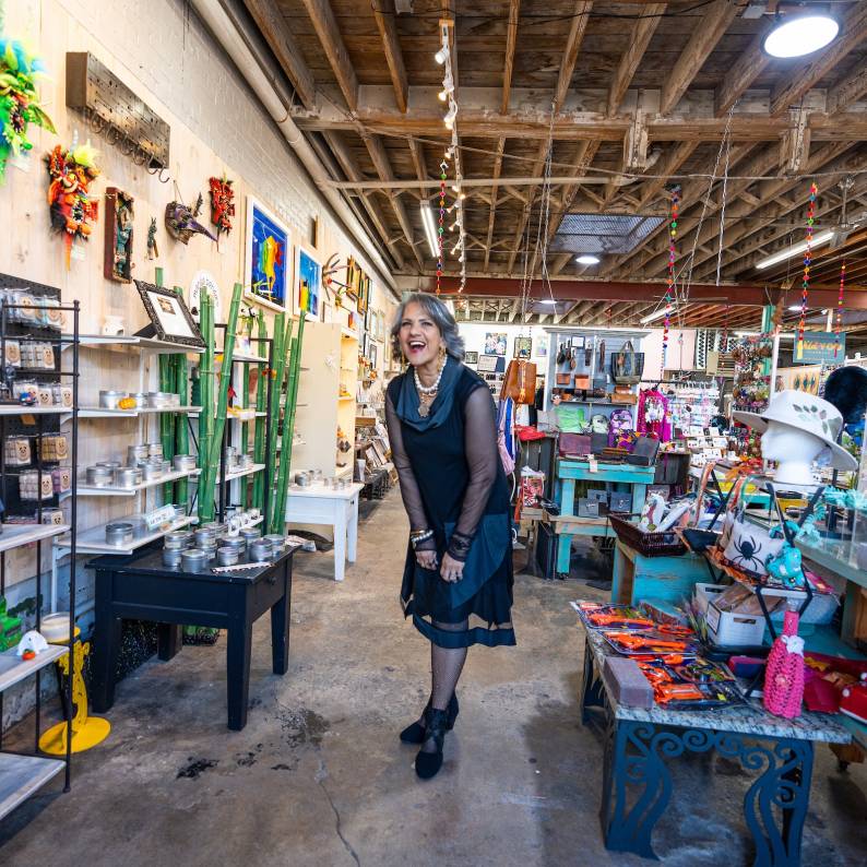 Portrait of gallery founder and owner, Cecilia Henaine de Davis among the merchandise at Cecy's Gallery & Studios
