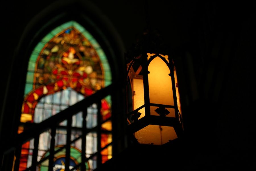 A light with a stained glass window in the background.