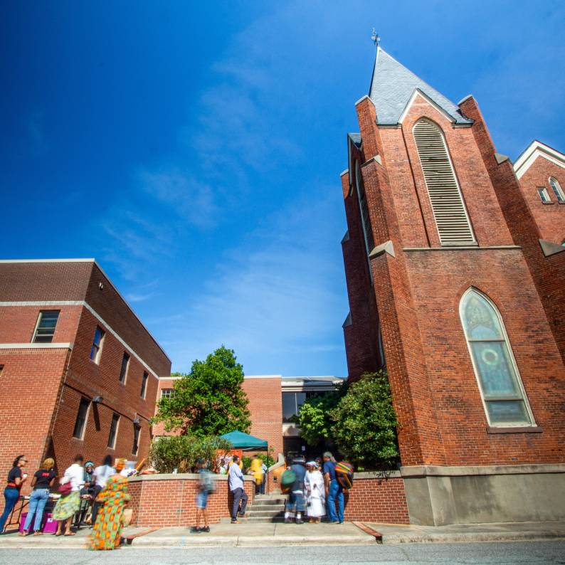 St. Joseph&#039;s AME Church stands tall on a sunny day under cloudless skies.