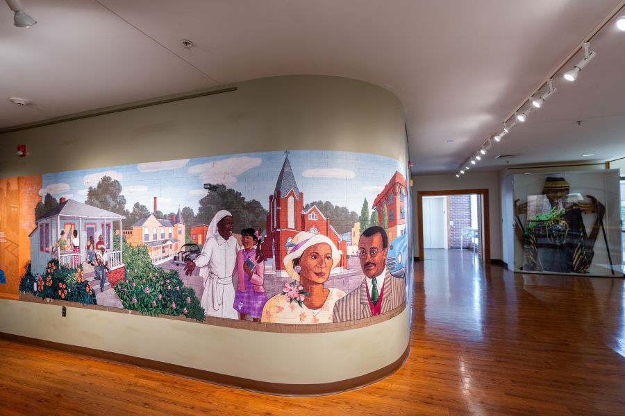 A recreated mural depicting life in Durham's Hayti district stretches across the wall of the Hayti Heritage Center.
