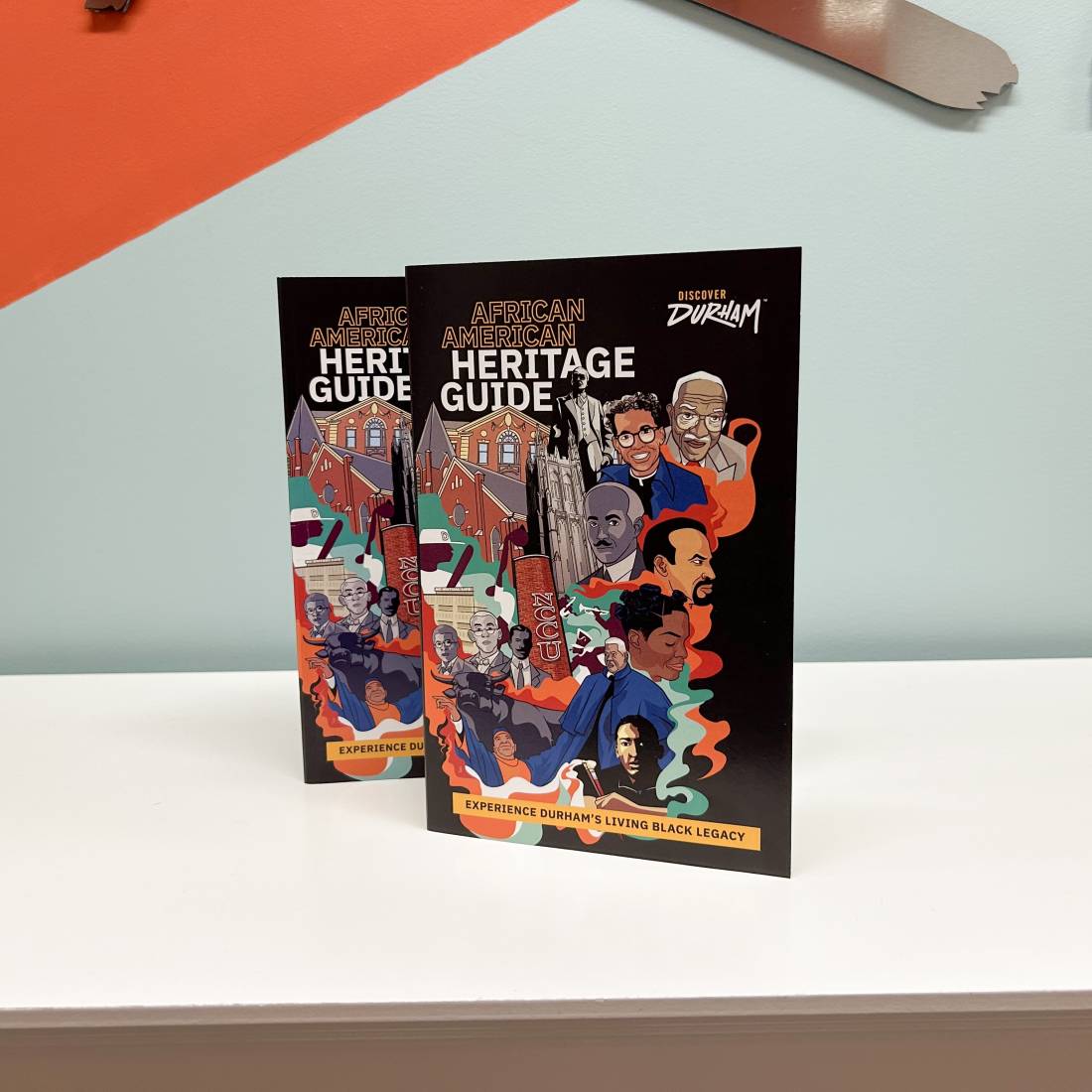 Two open copies of the Durham African American Heritage Guide stand on a tabletop.