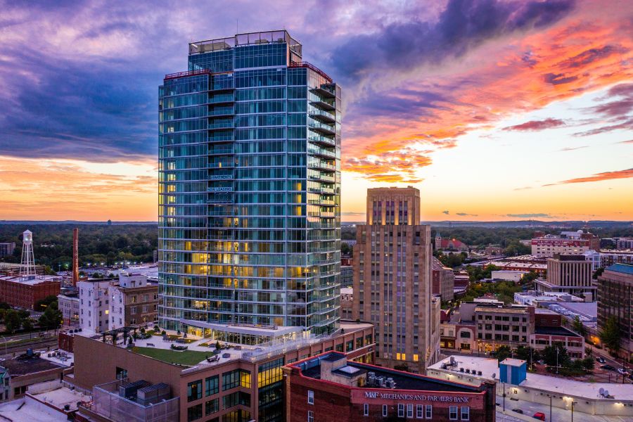 Sunburst clouds streak across the sky over Durham at sunset.