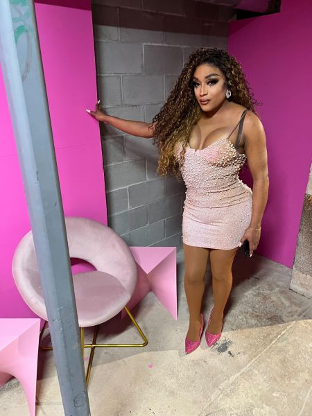 Naomi Dix of House of Coxx stands by a chair in Club ERA