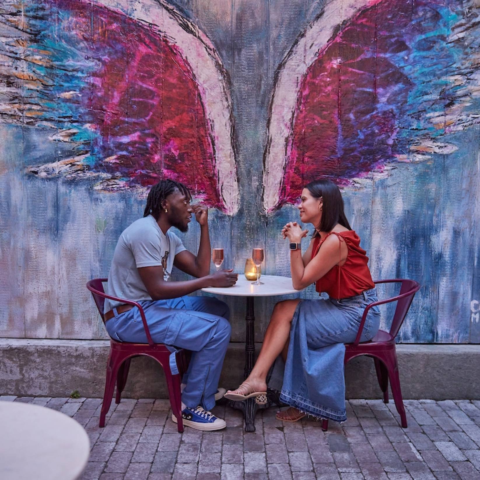 A enjoys sips of wine on a date night at the back patio of Killer Queen Wine Bar.