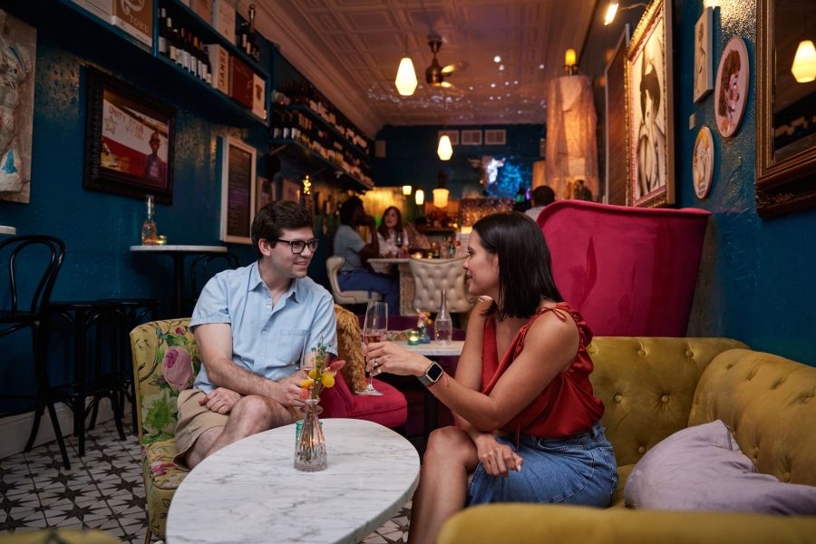 A couple enjoys a glass of wine at Killer Queen Wine Bar in Durham, NC