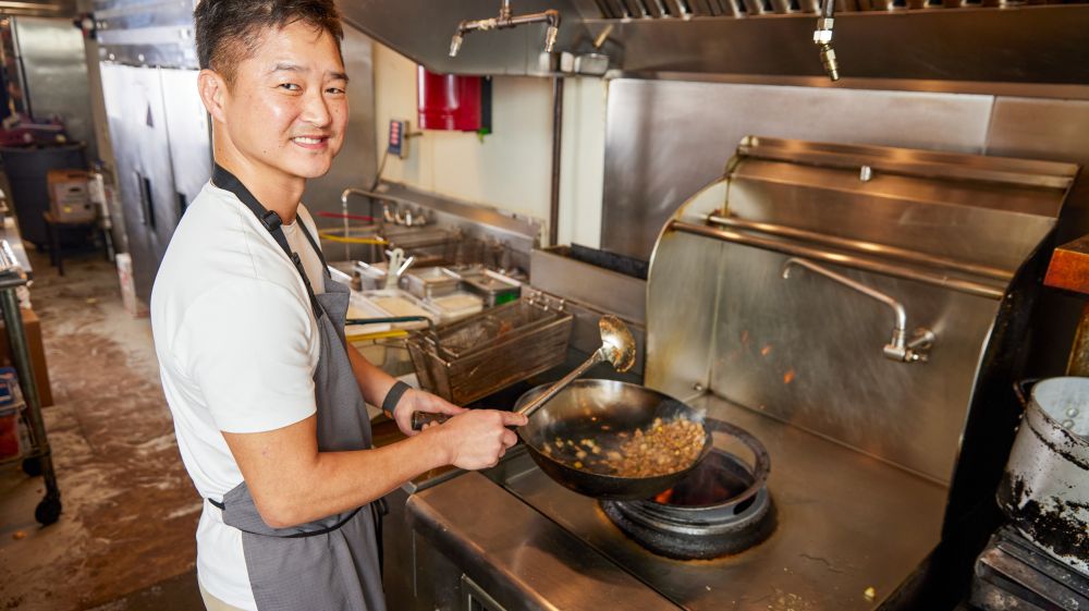 Chef Mike Lee cooks food on the stove at M Kokko