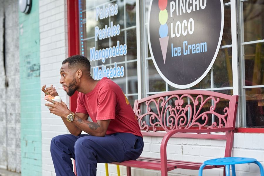 A man enjoys a cup of ice cream outside of Pincho Loco in Durham, NC.