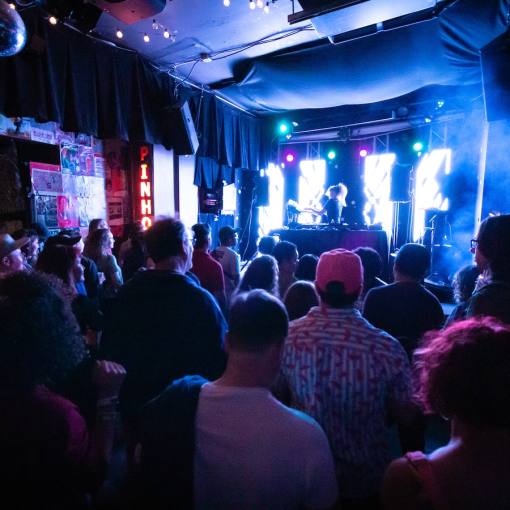 Concert goers gather around the stage at The Pinhook, enjoying a live performance.