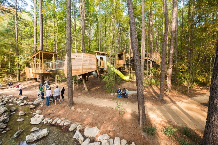 The tree forts of the Hideaway Woods Exhibit sit quietly amongst the trees.