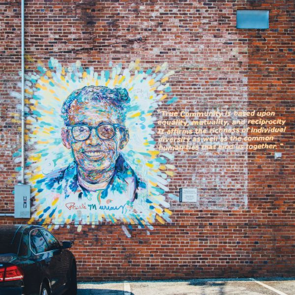 A colorful mural of Durham's Pauli Murray adorns a brick wall in Downtown Durham.
